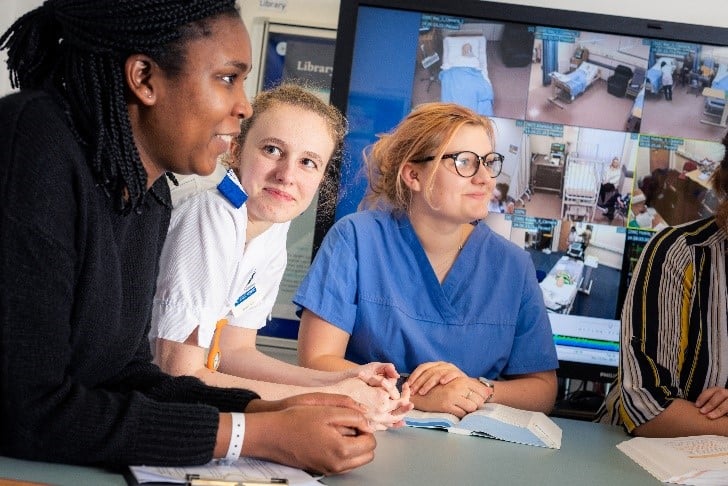 A group of clinicians having a discussion and smiling