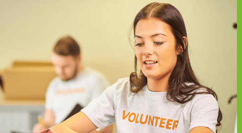 Image of a young woman with a t-chirt that says volunteer on the front