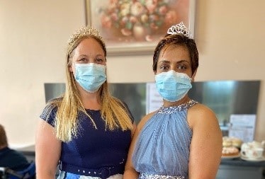 Photo of Kelly and Buddhi at a tie and tiaras event they held for their residents