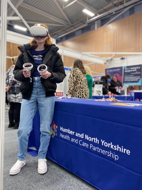 An attendee uses virtual reality to explore different health and care scenarios.